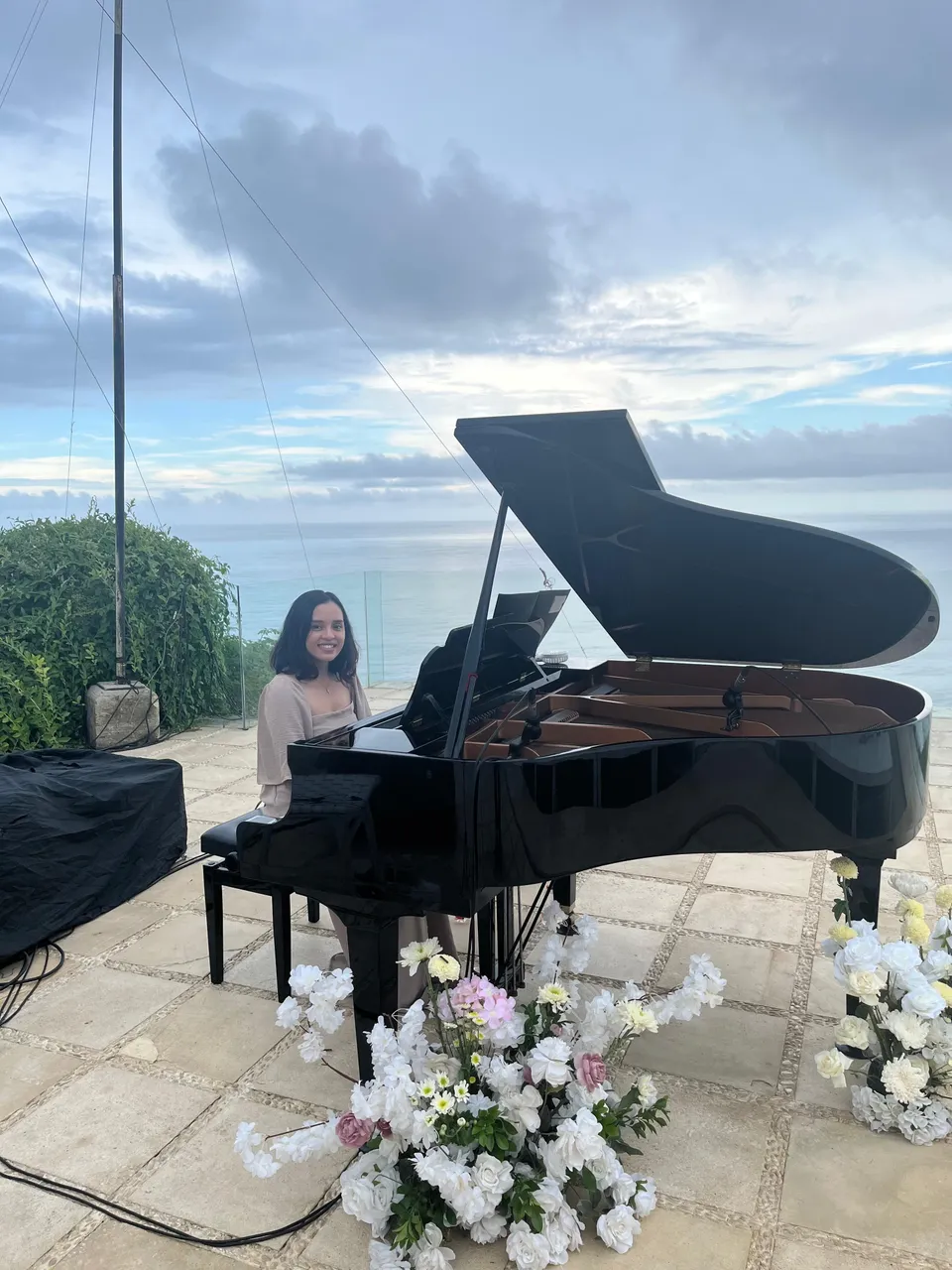 Wedding pianist performing solo piano at a cliffside wedding ceremony in Bali